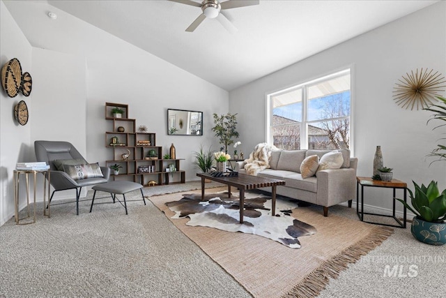 carpeted living room with ceiling fan, baseboards, and vaulted ceiling