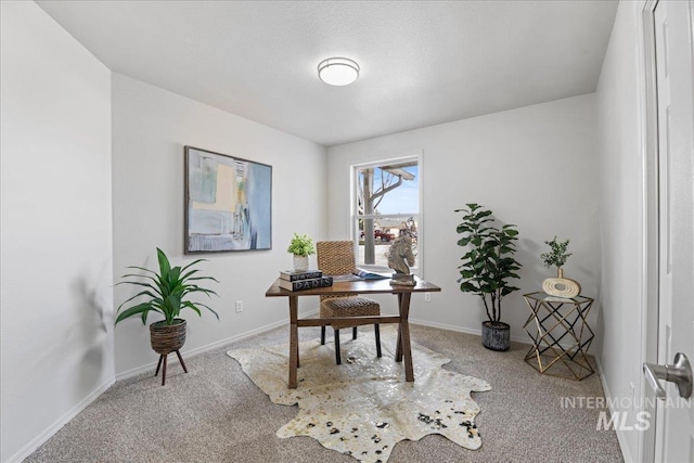 carpeted home office featuring baseboards