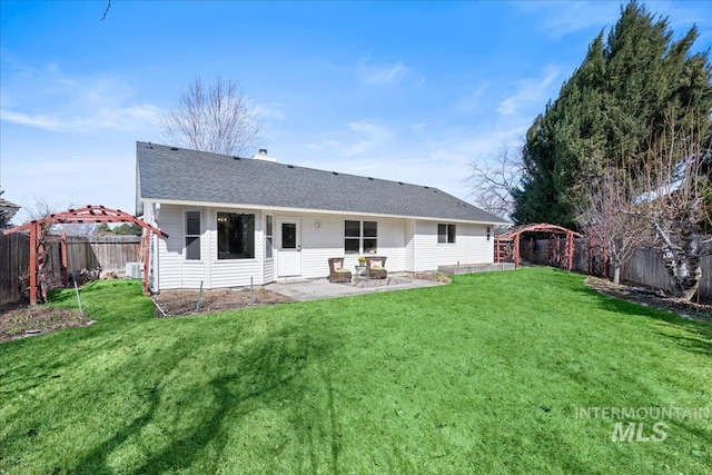 back of house featuring a fenced backyard, a patio, a gazebo, and a lawn