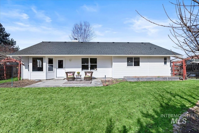 back of house featuring roof with shingles, fence, and a patio