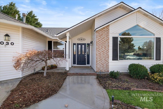 property entrance with brick siding