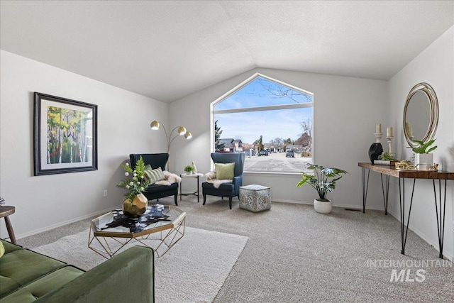 living area featuring a textured ceiling, baseboards, vaulted ceiling, and carpet flooring