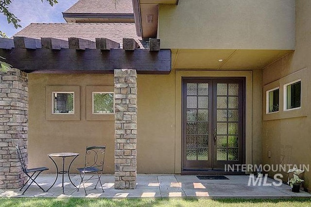 1878 W Sheep Hill Ct, Meridian, ID 83646 - view of exterior entry featuring french doors, stucco siding, and a patio