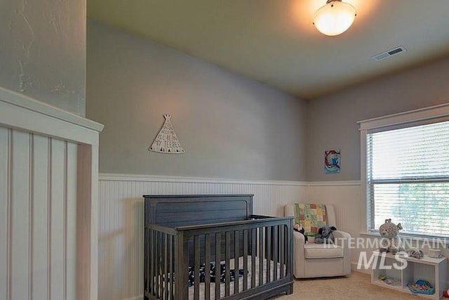 1878 W Sheep Hill Ct, Meridian, ID 83646 - carpeted bedroom featuring a wainscoted wall, multiple windows, and a crib