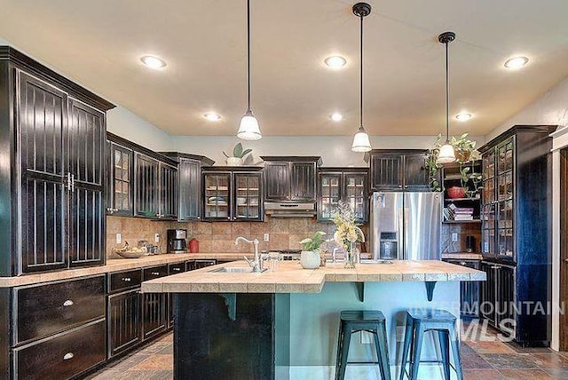 1878 W Sheep Hill Ct, Meridian, ID 83646 - kitchen with stainless steel fridge, under cabinet range hood, light countertops, backsplash, and recessed lighting