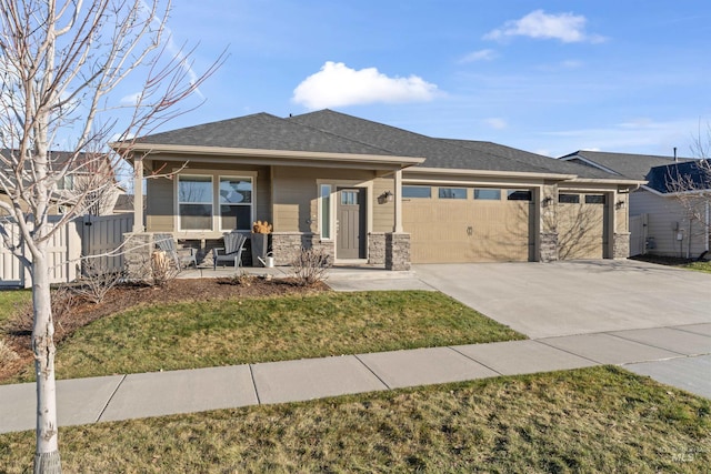 prairie-style home featuring a front yard and a garage