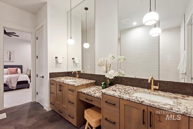 ensuite bathroom featuring two vanities and a ceiling fan