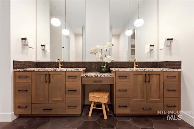 bathroom with tile patterned floors, vanity, and baseboards