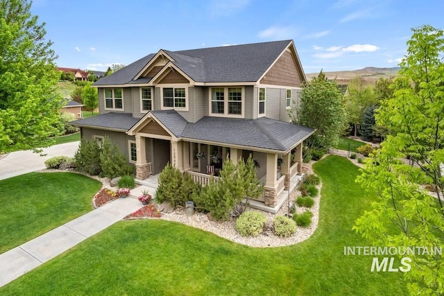 12507 N Humphreys Way, Boise, ID 83714 - craftsman house featuring covered porch, a front yard, driveway, and stone siding
