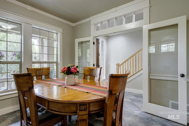12507 N Humphreys Way, Boise, ID 83714 - dining area featuring stone finish floors, stairs, baseboards, and ornamental molding