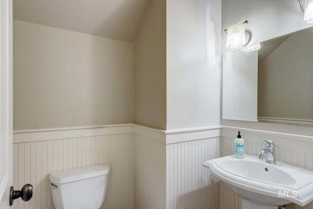 12507 N Humphreys Way, Boise, ID 83714 - half bathroom with wainscoting, a sink, and toilet