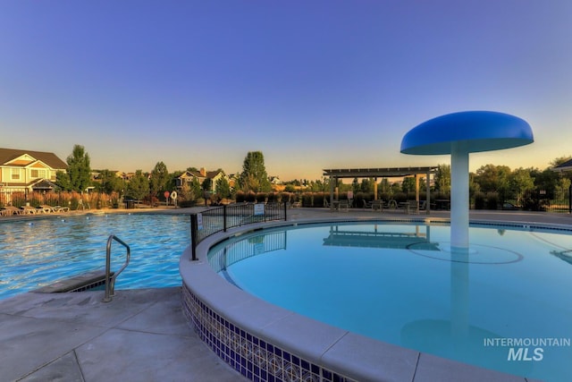 12507 N Humphreys Way, Boise, ID 83714 - pool at dusk featuring a community pool and a pergola