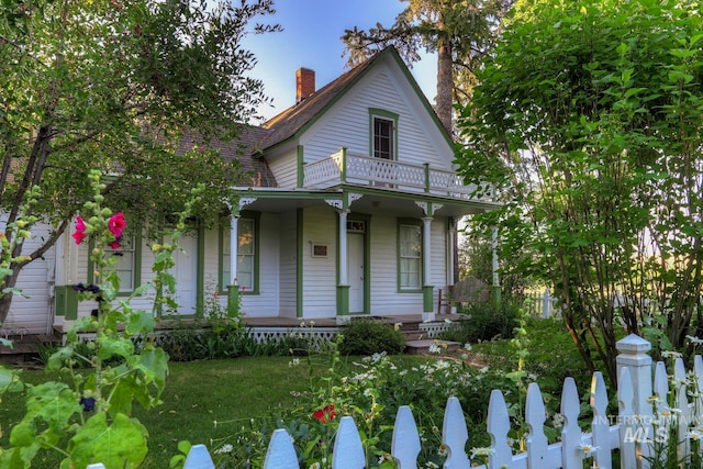 12507 N Humphreys Way, Boise, ID 83714 - view of front facade featuring a porch, a balcony, and a chimney