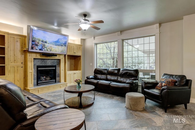 12507 N Humphreys Way, Boise, ID 83714 - living room featuring ceiling fan, a high end fireplace, stone finish floors, and baseboards