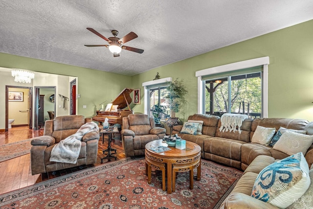 911 Davis, Mccall, ID 83638 - living room featuring a textured ceiling, plenty of natural light, a ceiling fan, hardwood / wood-style flooring, and a chandelier
