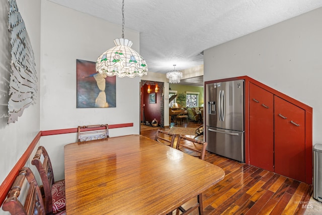 911 Davis, Mccall, ID 83638 - dining room featuring a textured ceiling, wood finished floors, and a chandelier
