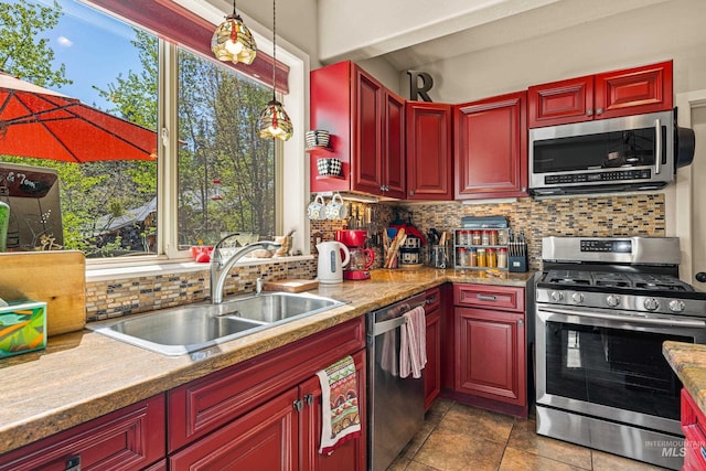911 Davis, Mccall, ID 83638 - kitchen featuring appliances with stainless steel finishes, reddish brown cabinets, a sink, and tasteful backsplash