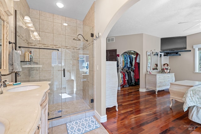 911 Davis, Mccall, ID 83638 - full bath with wood finished floors, a shower stall, vanity, a walk in closet, and baseboards