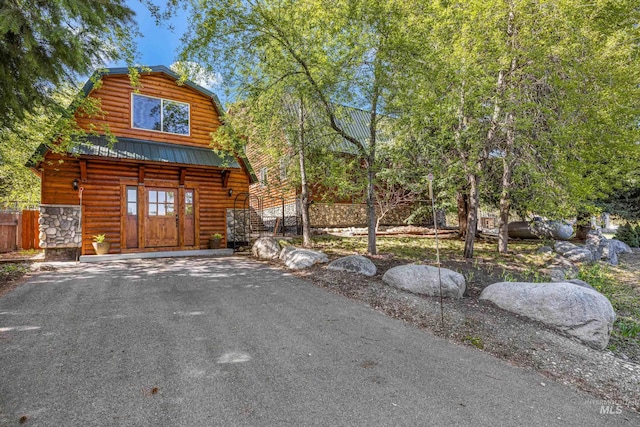 911 Davis, Mccall, ID 83638 - view of front of house featuring metal roof, a gambrel roof, and asphalt driveway