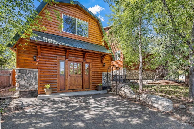 911 Davis, Mccall, ID 83638 - view of front of home featuring a gambrel roof, metal roof, and a patio