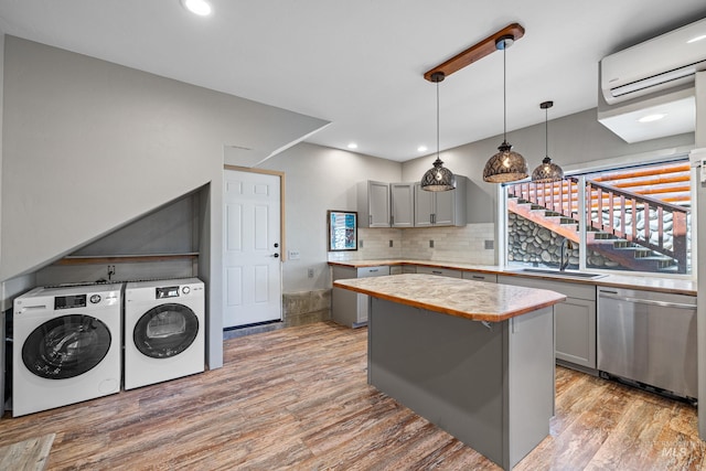 911 Davis, Mccall, ID 83638 - kitchen featuring separate washer and dryer, dishwasher, a wall mounted air conditioner, gray cabinets, and recessed lighting