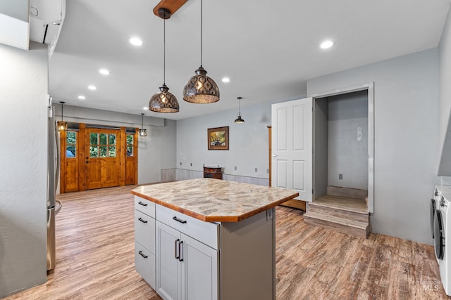 911 Davis, Mccall, ID 83638 - kitchen featuring light wood finished floors, independent washer and dryer, light countertops, recessed lighting, and a center island