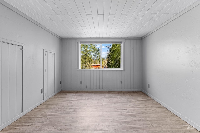 911 Davis, Mccall, ID 83638 - unfurnished bedroom with light wood-style flooring, multiple closets, baseboards, and wood ceiling