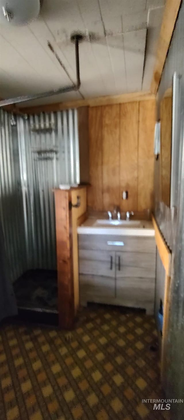 bathroom featuring wooden walls