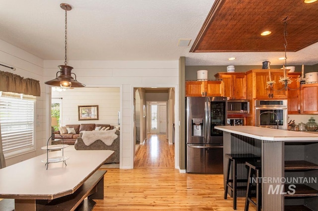 8344 Partridge Dr, Nampa, ID 83686 - kitchen with light countertops, light wood finished floors, a center island, and stainless steel appliances