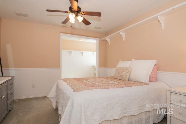 8344 Partridge Dr, Nampa, ID 83686 - carpeted bedroom with a wainscoted wall and a ceiling fan