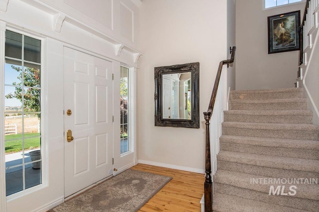 8344 Partridge Dr, Nampa, ID 83686 - entrance foyer with light wood-style flooring, baseboards, and stairs