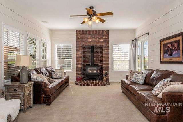 8344 Partridge Dr, Nampa, ID 83686 - carpeted living area with a ceiling fan, a wood stove, visible vents, and a healthy amount of sunlight