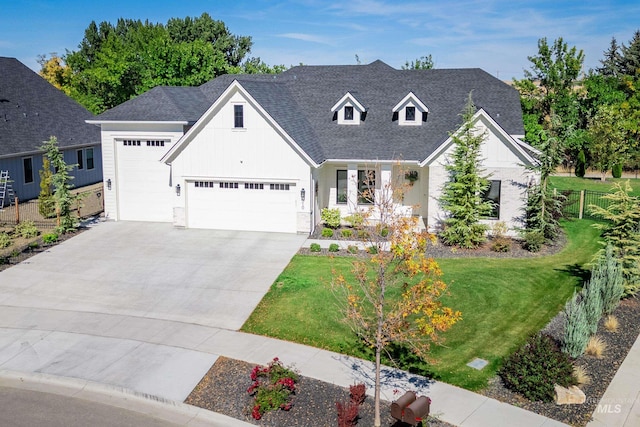 view of front of home featuring a front yard and a garage