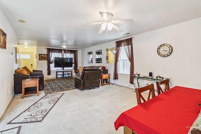 dining area featuring ceiling fan and carpet