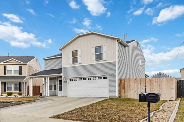 traditional-style home with concrete driveway, fence, and an attached garage