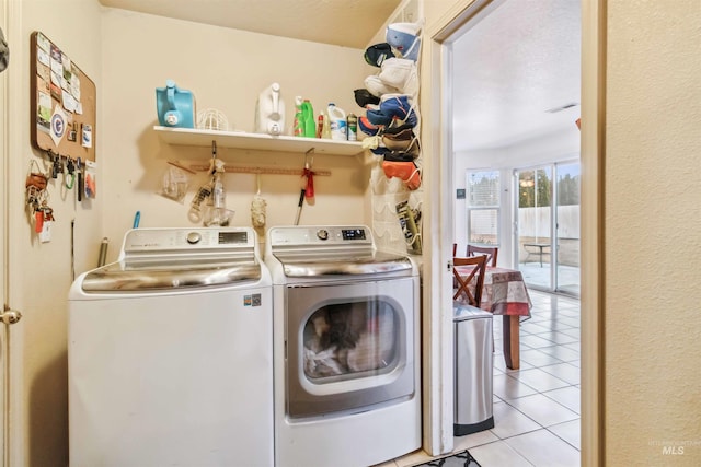 laundry area with washing machine and dryer, laundry area, and light tile patterned flooring