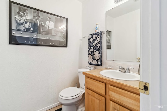 half bathroom with toilet and vanity