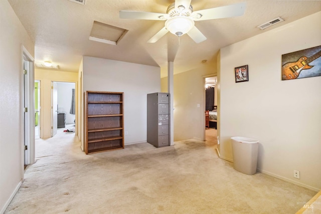 bedroom with visible vents, baseboards, attic access, and light colored carpet