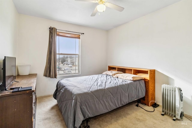 bedroom featuring radiator heating unit, a ceiling fan, and light colored carpet