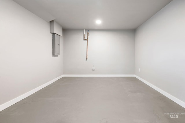 finished basement featuring electric panel and baseboards