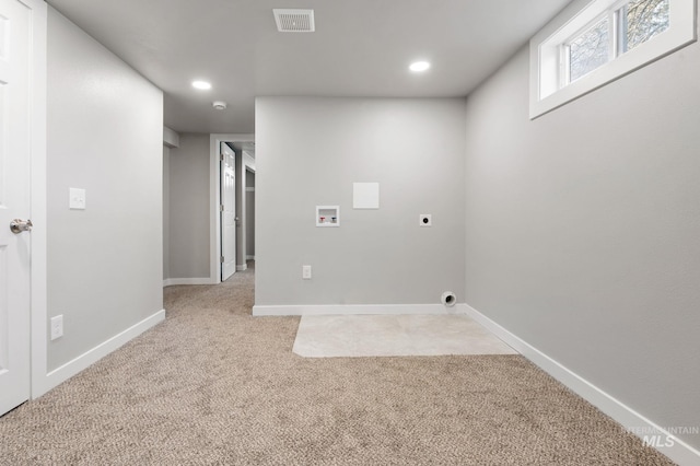 clothes washing area featuring hookup for a washing machine, light colored carpet, electric dryer hookup, laundry area, and baseboards