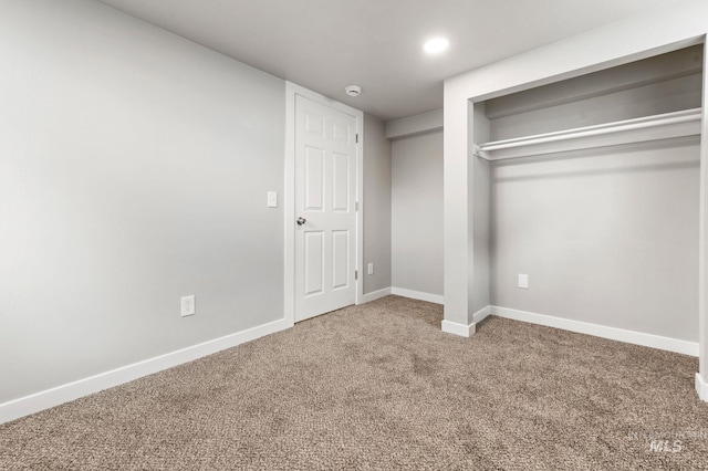 unfurnished bedroom featuring carpet flooring and baseboards