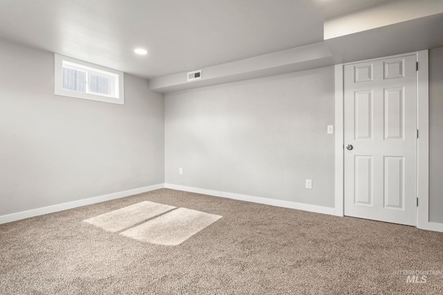 basement featuring carpet floors, recessed lighting, visible vents, and baseboards