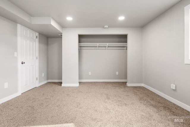 unfurnished bedroom with carpet, baseboards, a closet, and recessed lighting