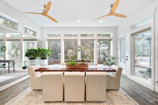 sunroom / solarium featuring a ceiling fan