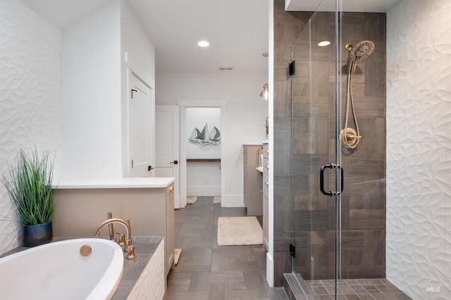 full bath with baseboards, a shower stall, a bath, and recessed lighting