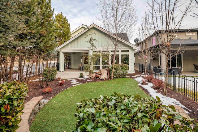 back of property featuring a patio area, a fenced backyard, and a lawn