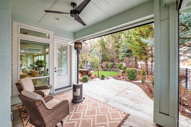 view of patio with ceiling fan and fence