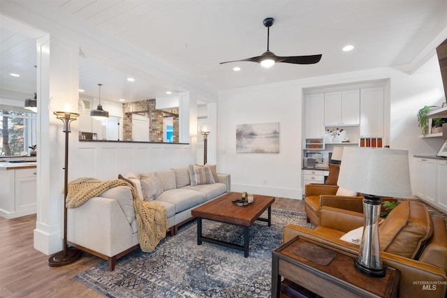 living room with ceiling fan, wood finished floors, and recessed lighting