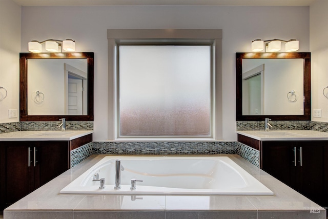 bathroom featuring vanity and a relaxing tiled tub